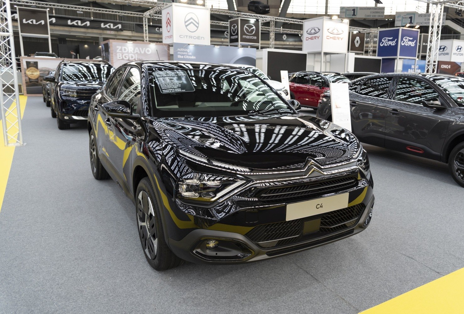Front fascia and LED headlights of a black 2020 model showcased indoors