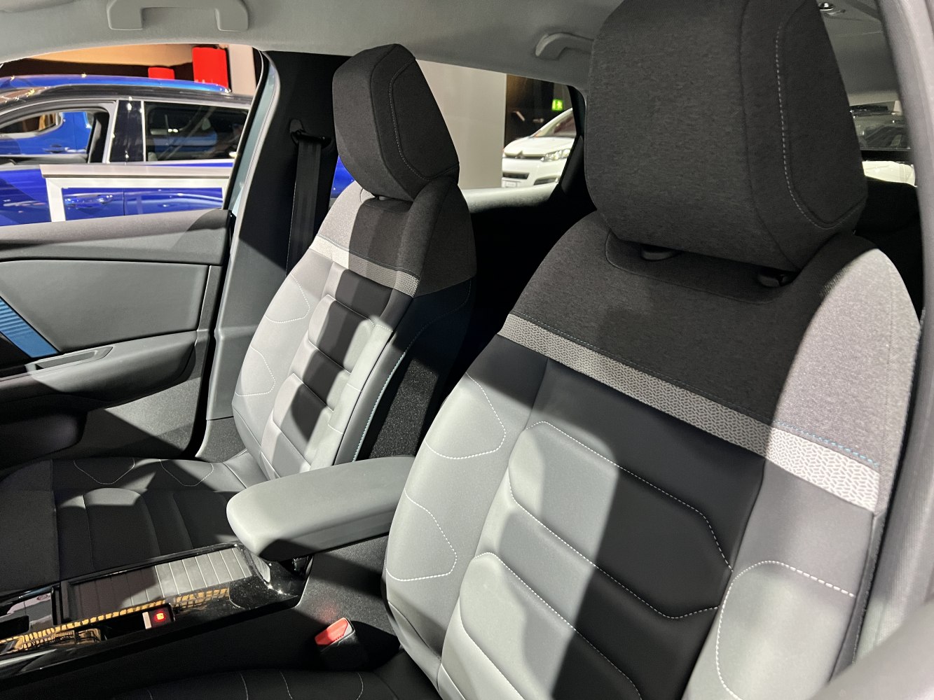 Fabric and leather front seats with detailed stitching and armrest