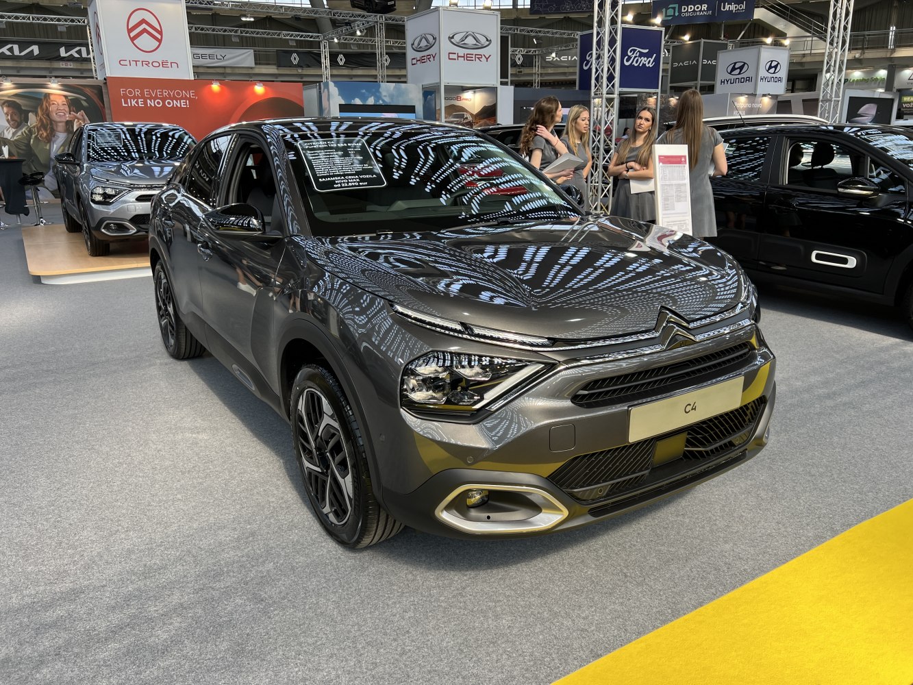 Sleek front fascia with distinctive headlights and side view of modern hatchback.