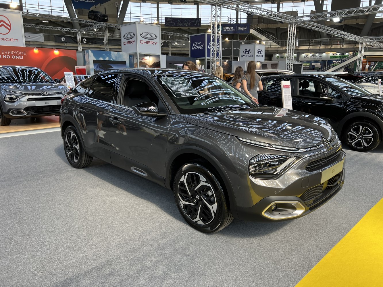 Front and side view of a compact SUV with distinct headlights and alloy wheels