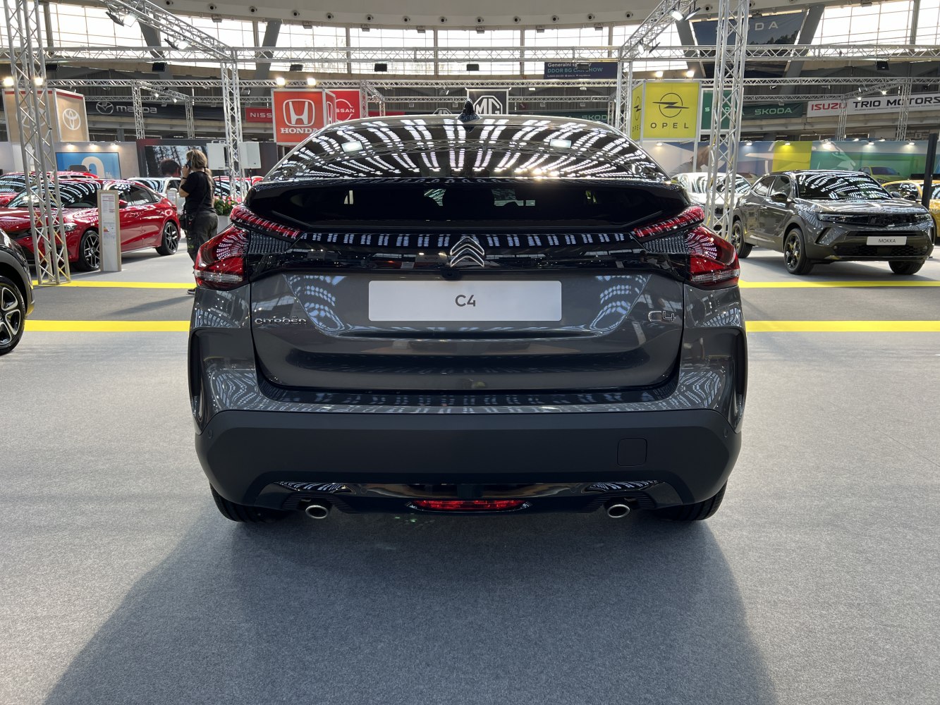 Rear view of hatchback with split taillights and dual exhaust