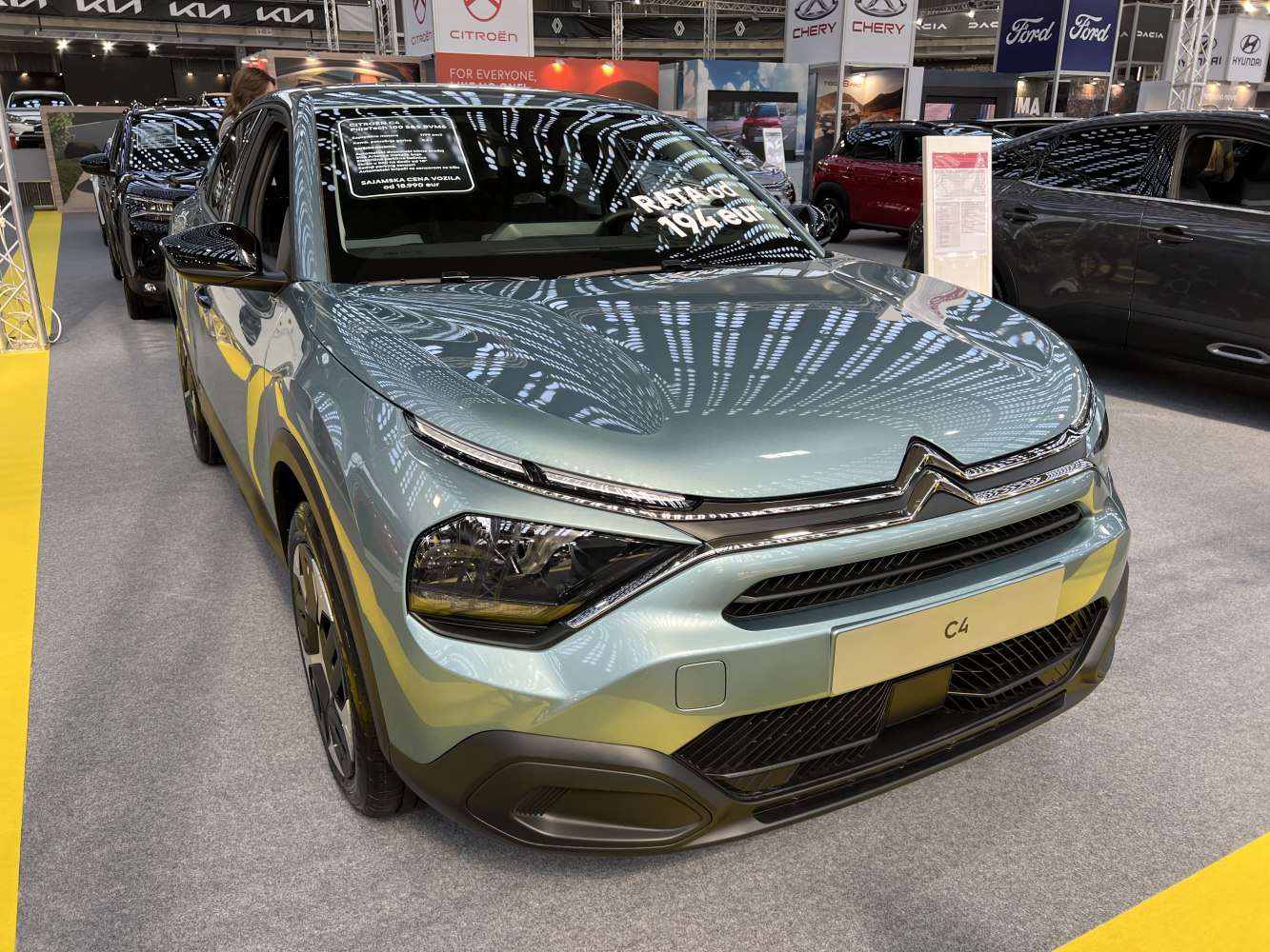 Close-up front view of compact hatchback with distinct headlights and grille