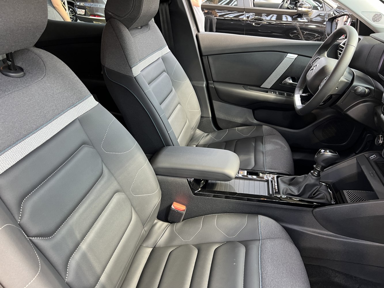 Modern interior with ergonomic seats, armrest, and dashboard layout