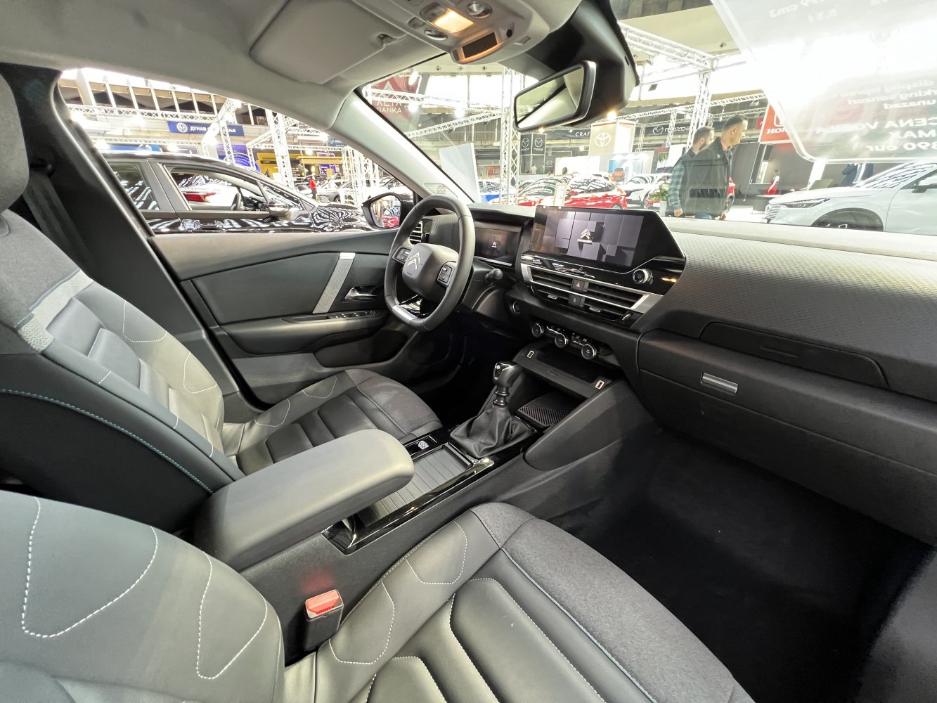 Digital instrument cluster and touchscreen with manual gear shifter and luxury fabric seats