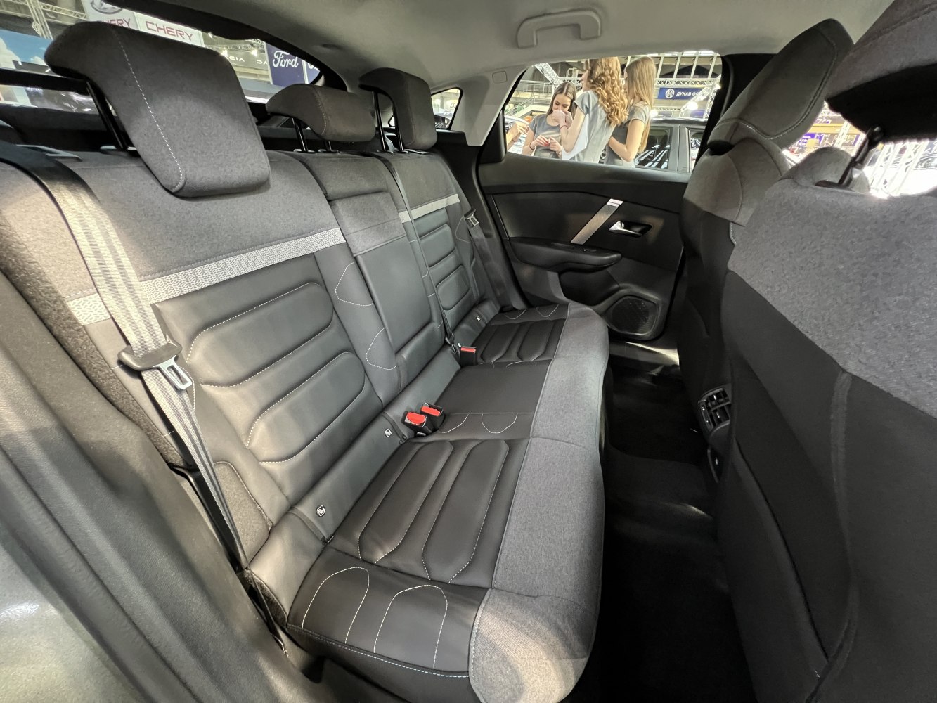 Leather and fabric rear seats with headrests and detailed stitching