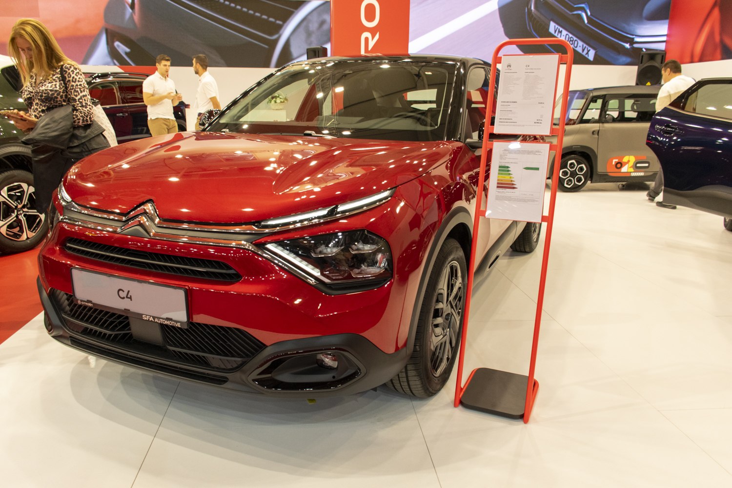 Red car front with sleek headlights and bold grille design
