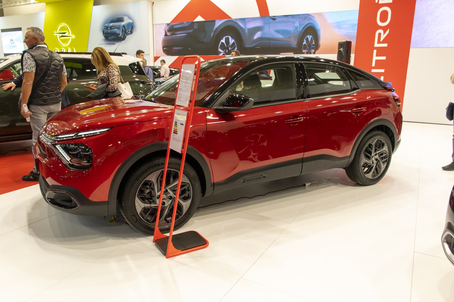Red compact SUV with black roof and modern alloy wheels