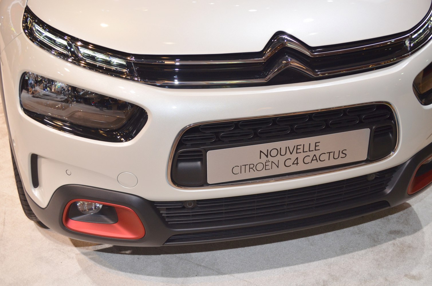 Close-up of front grille and modern headlights with fog lamps