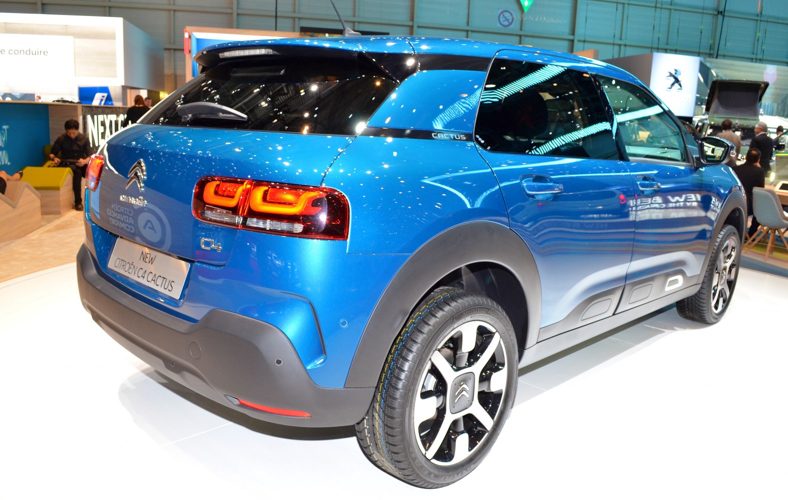 Rear and side view with tail lights, protective side panels, and blue finish