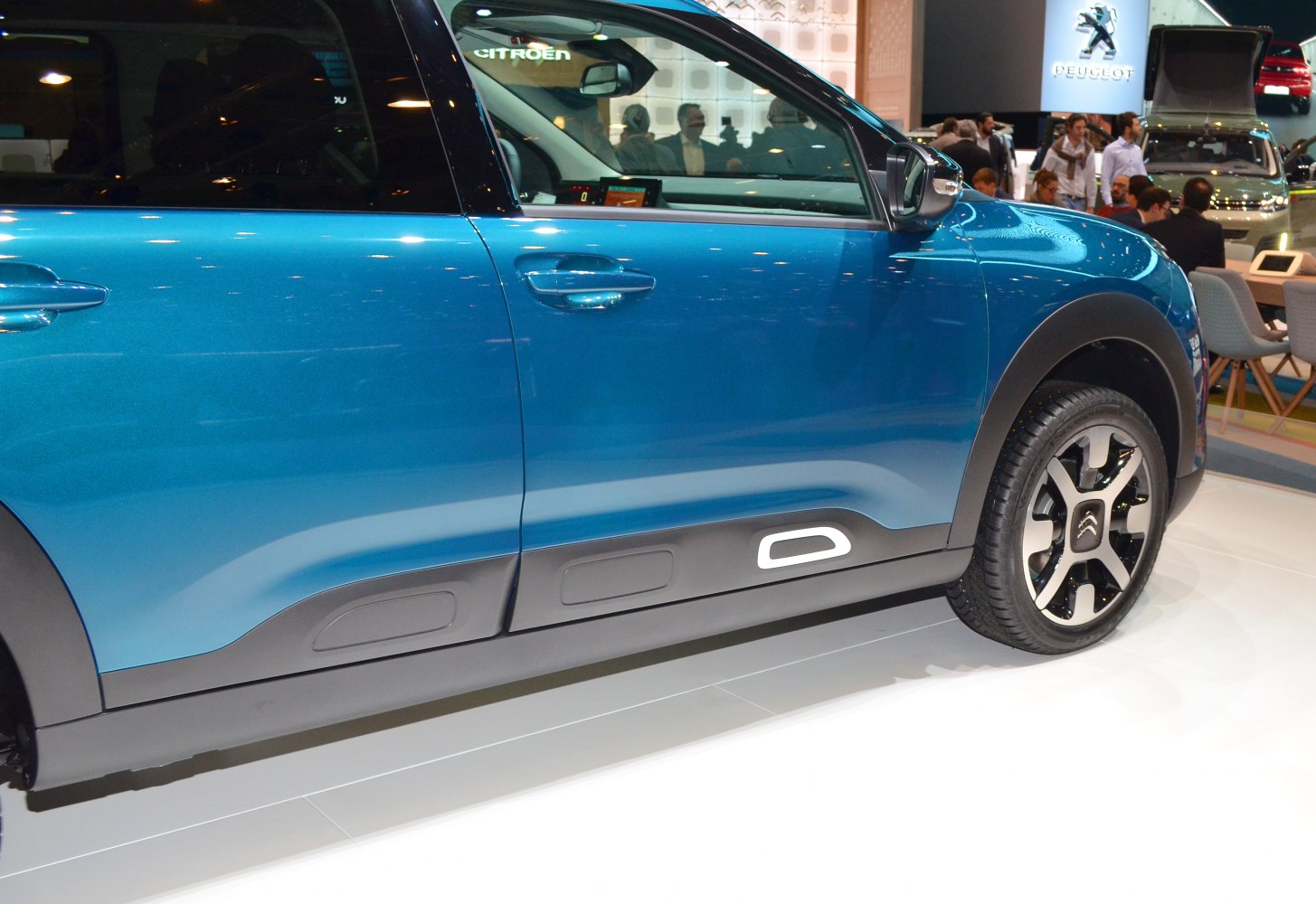 Close-up of side profile, door panels, and alloy wheel with modern design.