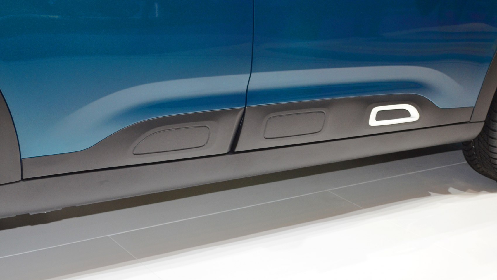 Textured side door protective panels with distinctive inserts