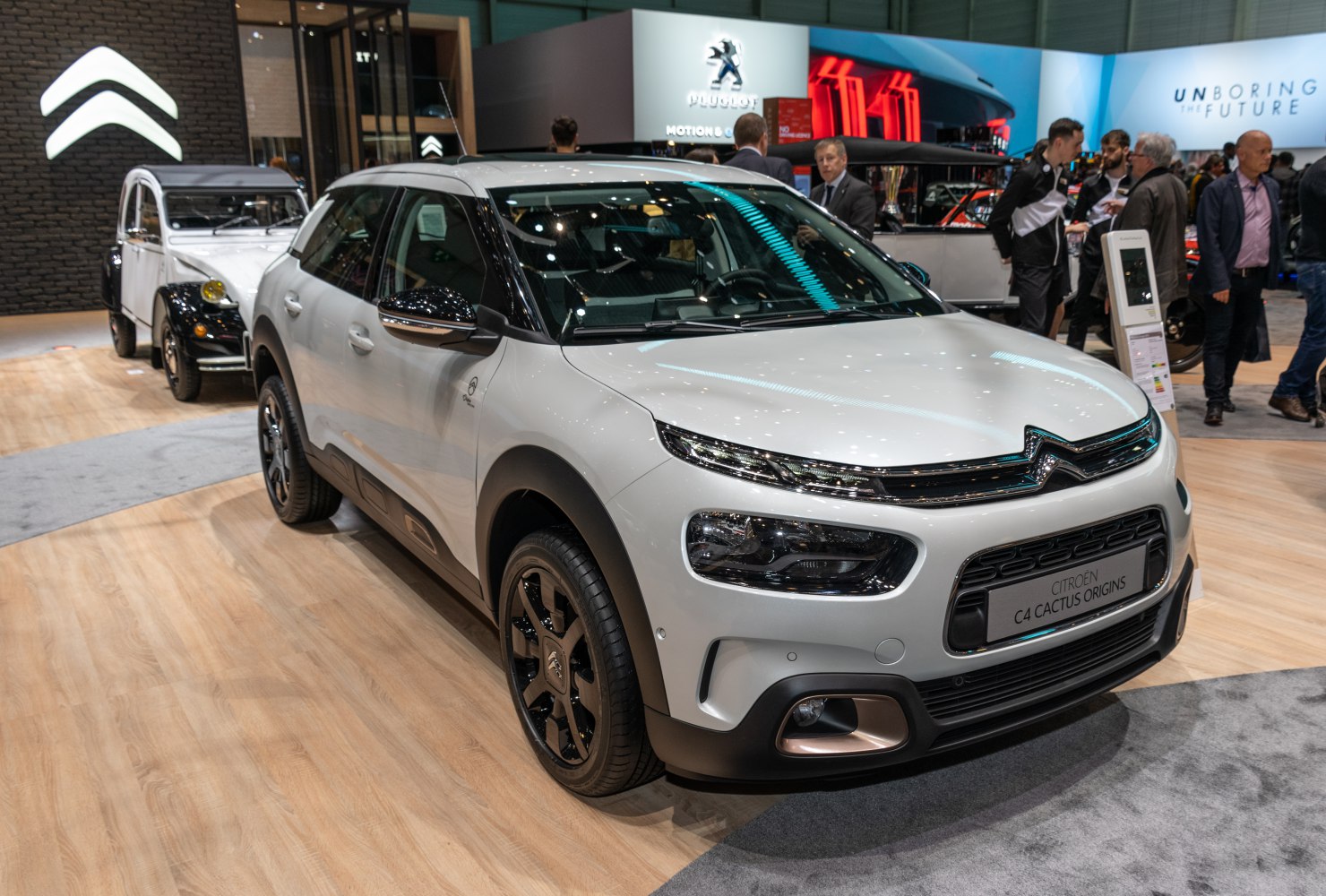 Front and side view of a modern SUV with distinctive headlights and black alloy wheels