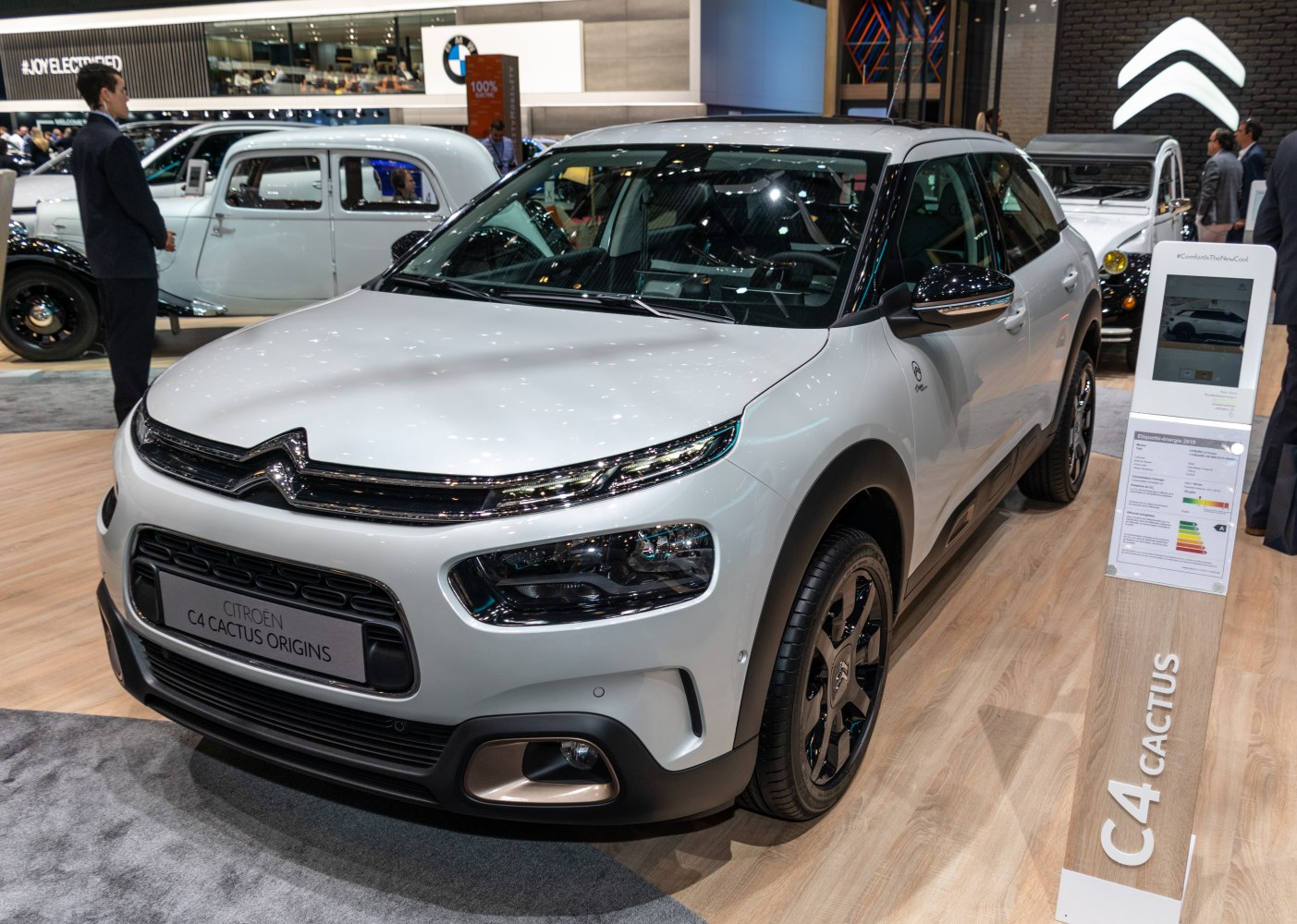 Front and side view of a modern compact SUV with sleek headlights and distinctive black rims.