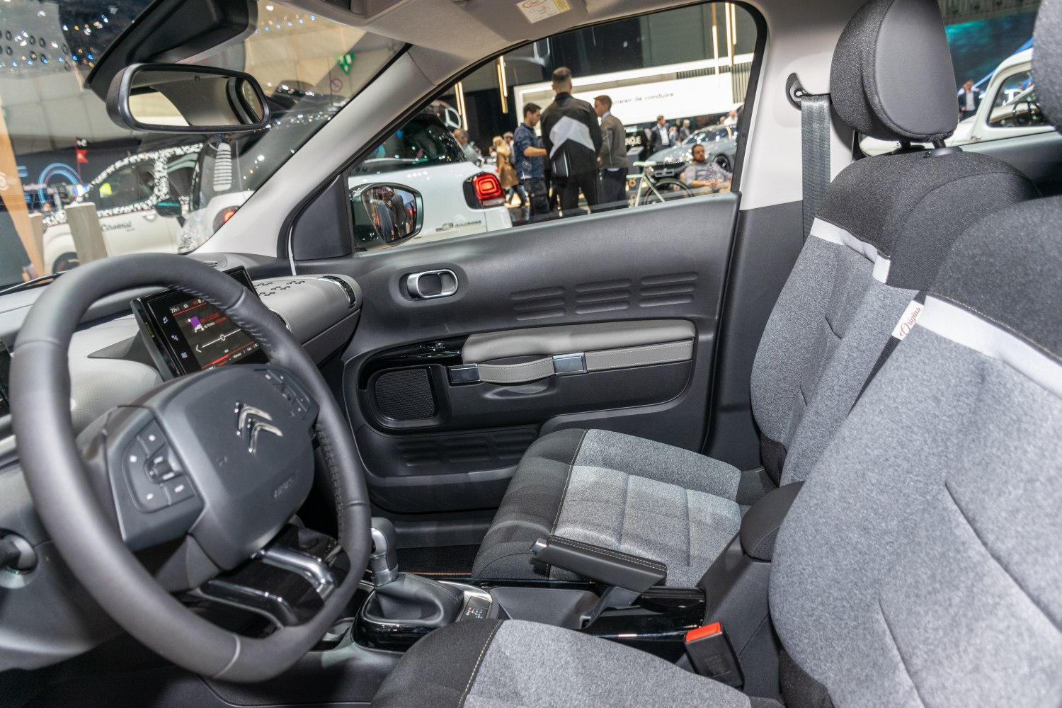 Modern cabin with fabric seats and detailed dashboard