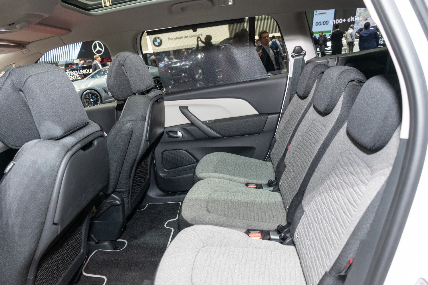 Rear seats with fabric upholstery and headrests inside a spacious car cabin