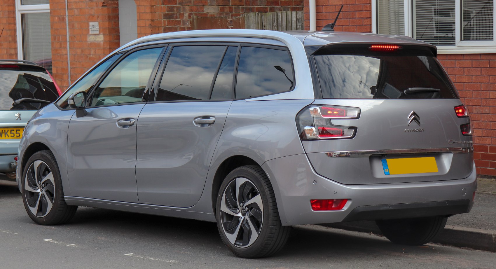 Rear side view with distinctive taillights and alloy wheels.
