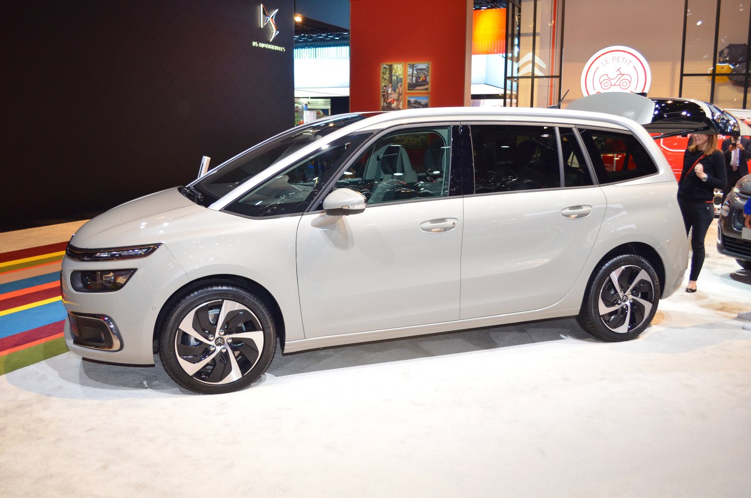Side profile of minivan with open trunk and alloy wheels