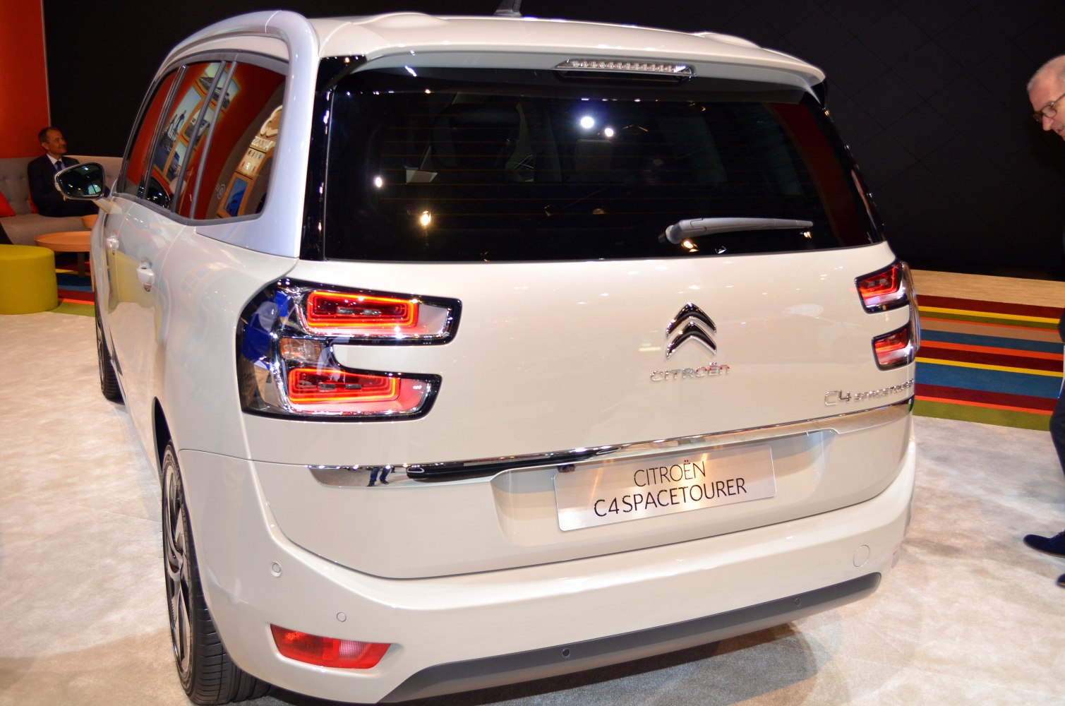 Rear view with unique multi-level LED taillights on a white MPV
