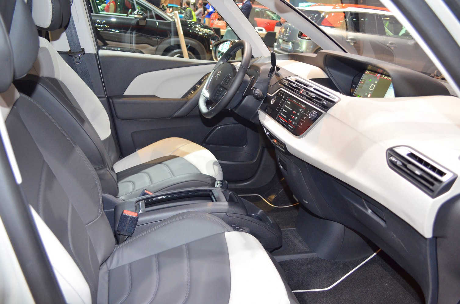 Front interior cabin with dashboard, steering wheel, and leather seats