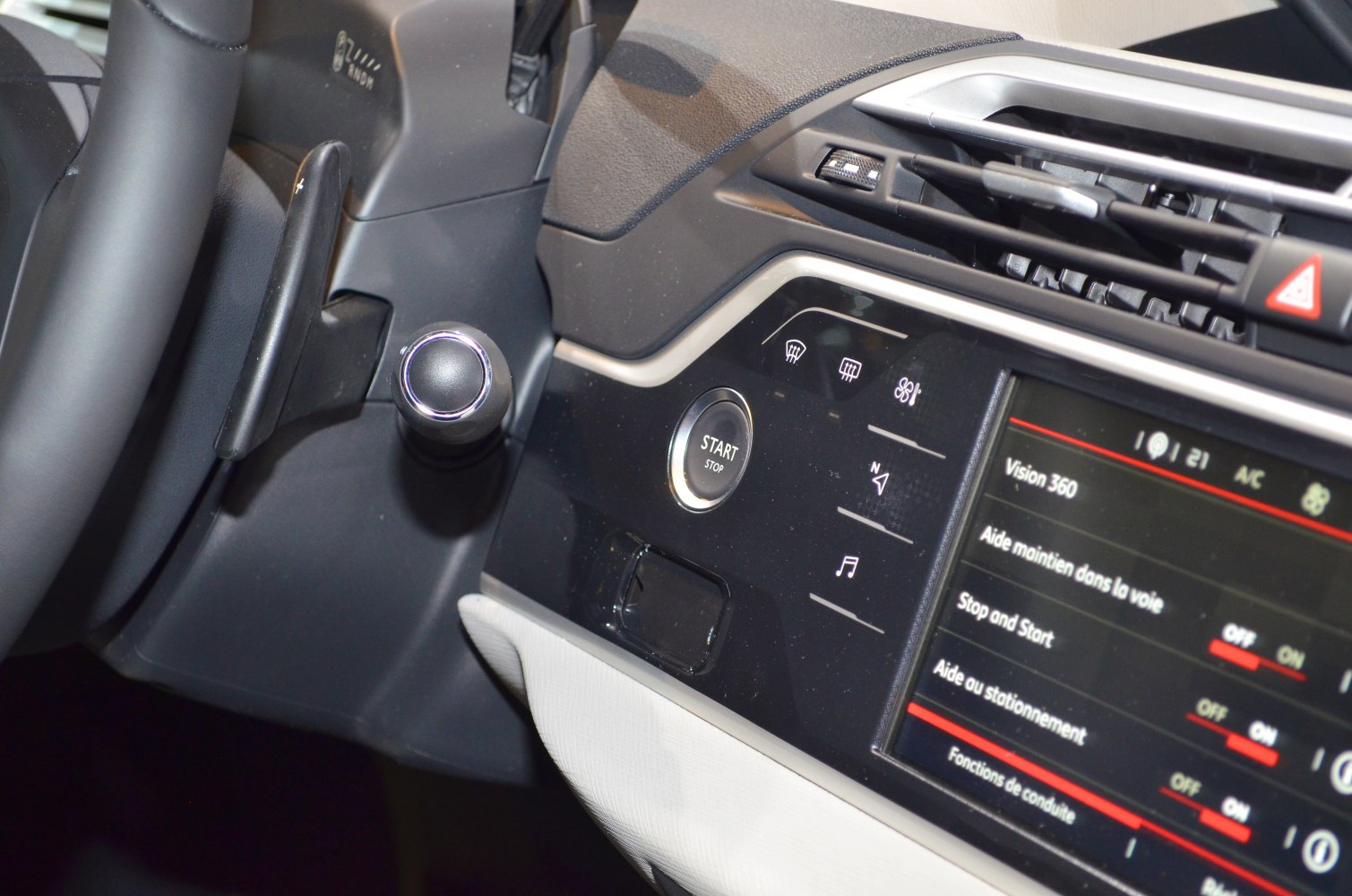 Start/stop button, infotainment system, and climate control panel