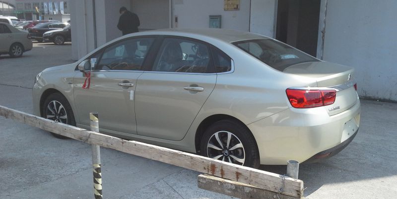 Silver sedan with alloy wheels and rear spoiler