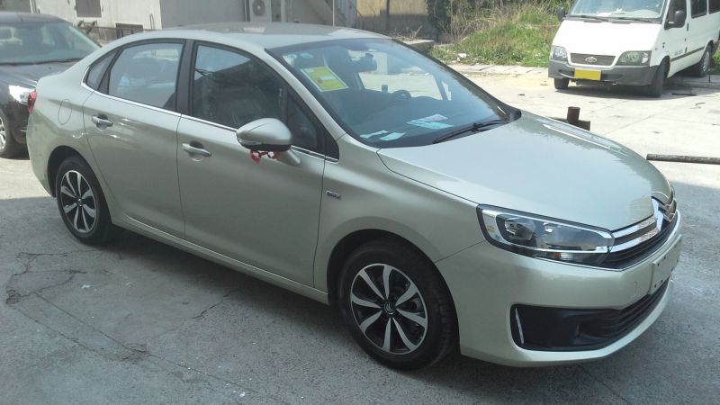 Silver 2015 sedan front-side view with alloy wheels