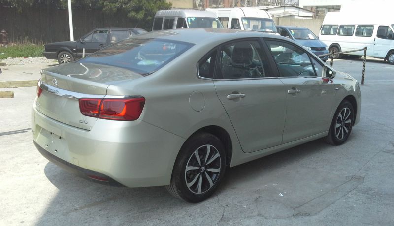 Rear side view of a sedan with distinctive taillights and alloy wheels