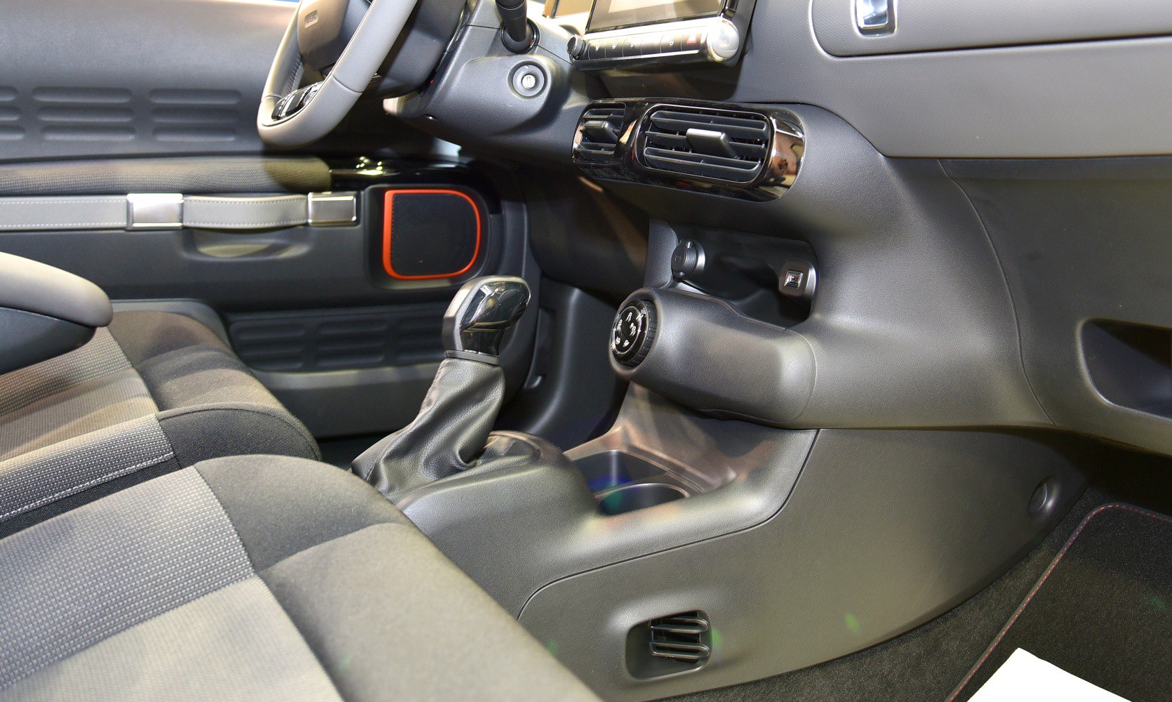 Interior with manual gear shift, air vents, and distinctive door panel elements