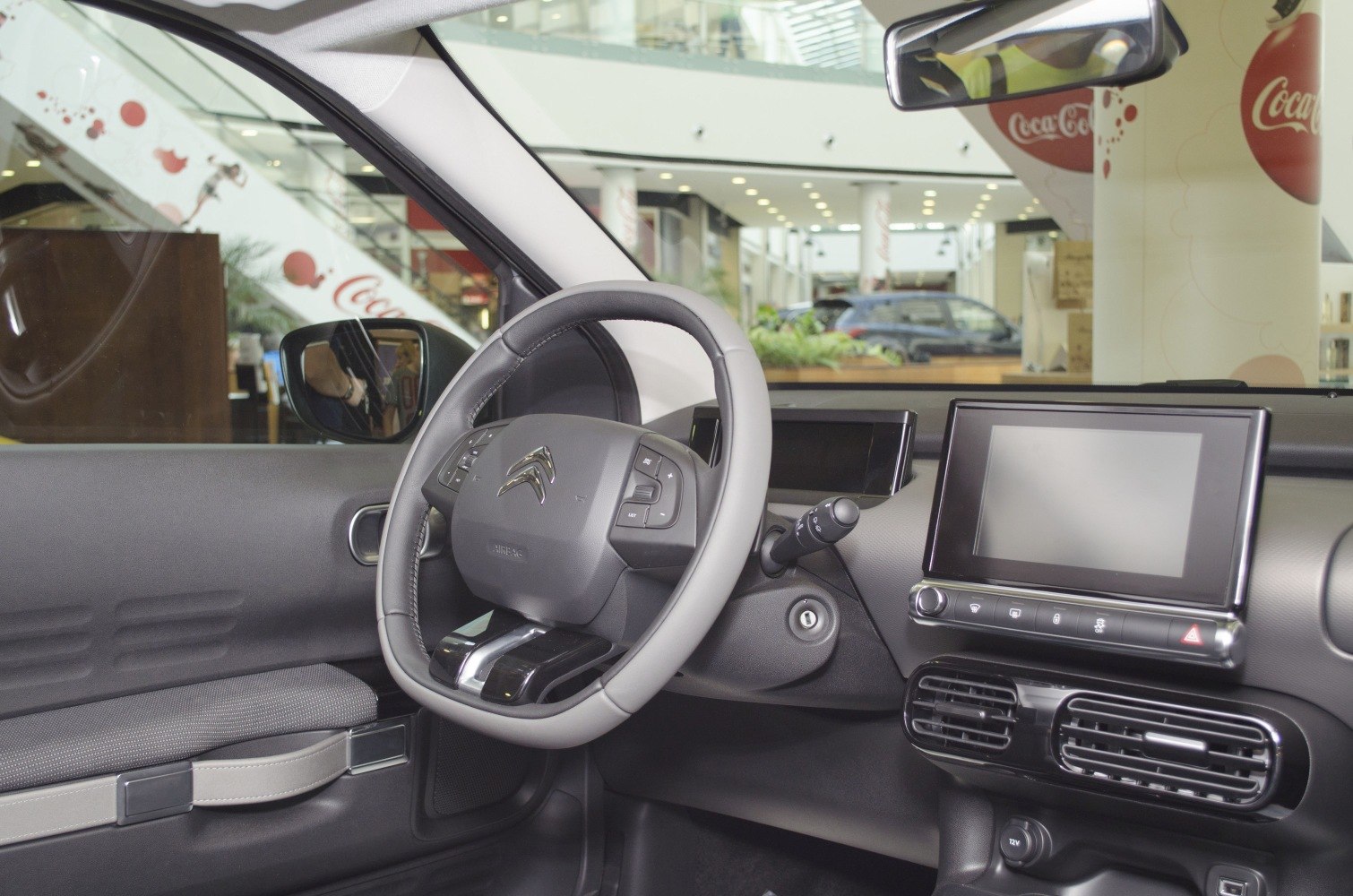 Dashboard and steering wheel with infotainment screen and air vents