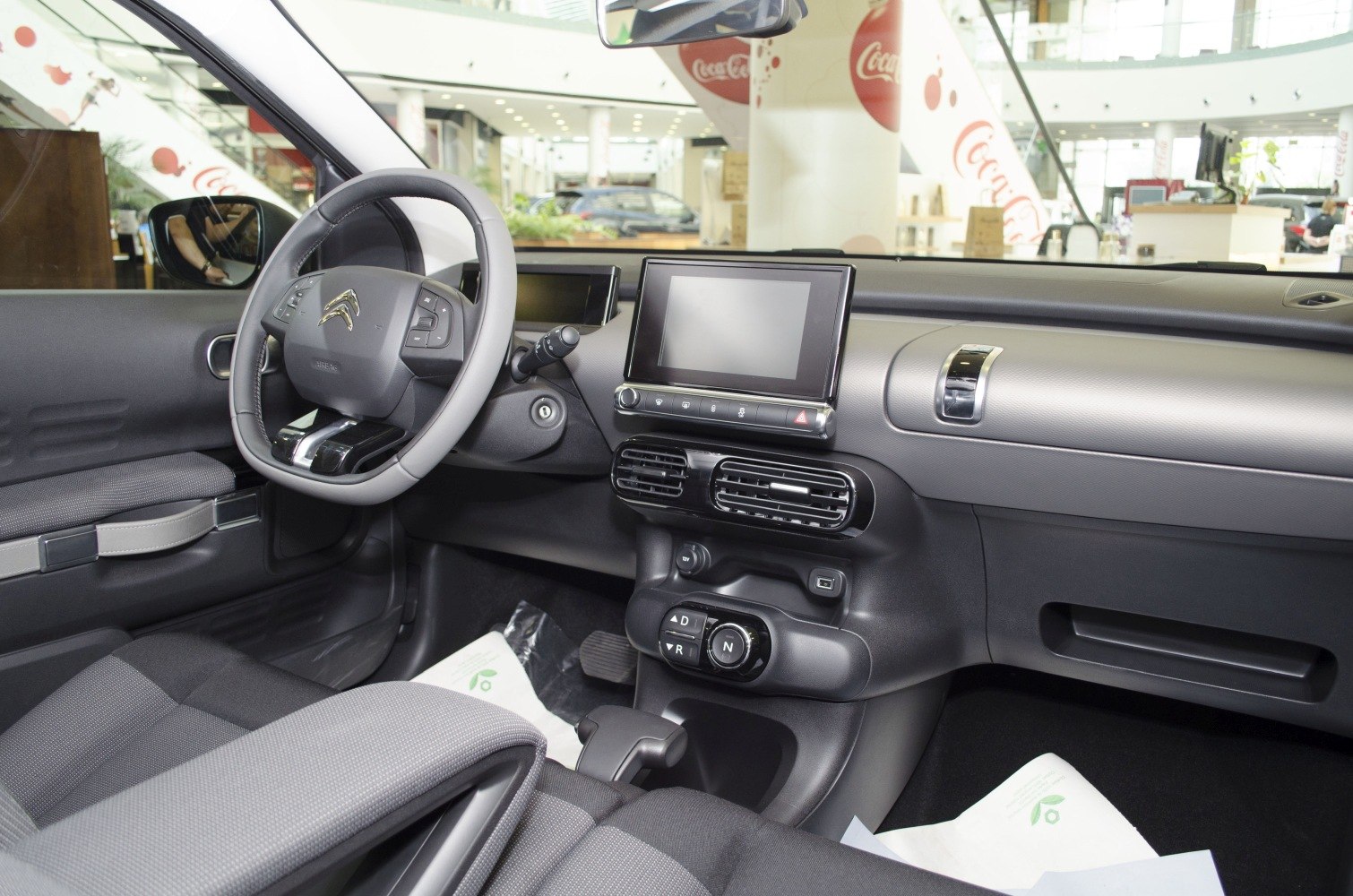 Touchscreen dashboard and multifunction steering wheel in compact car interior