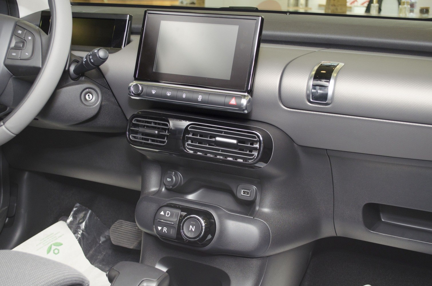 Touchscreen infotainment display and unique gear selector on dashboard