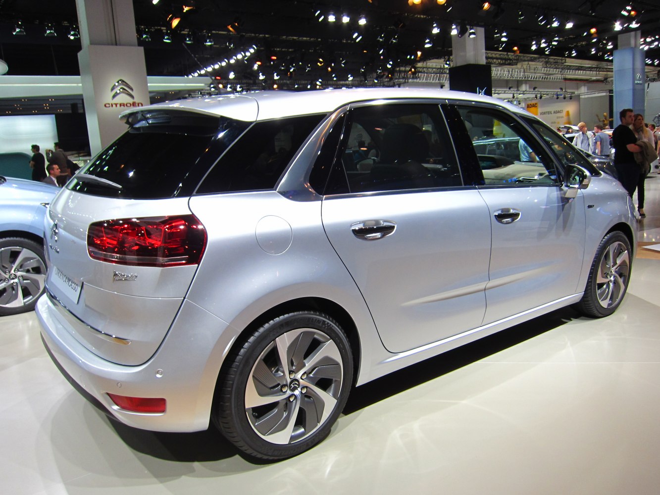 Rear side view of silver compact hatchback with distinctive tail lights and alloy wheels