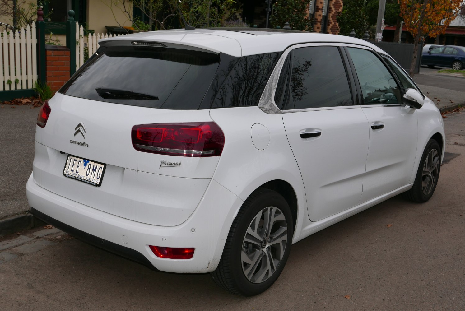 Rear view of white hatchback with modern taillights and alloy wheels