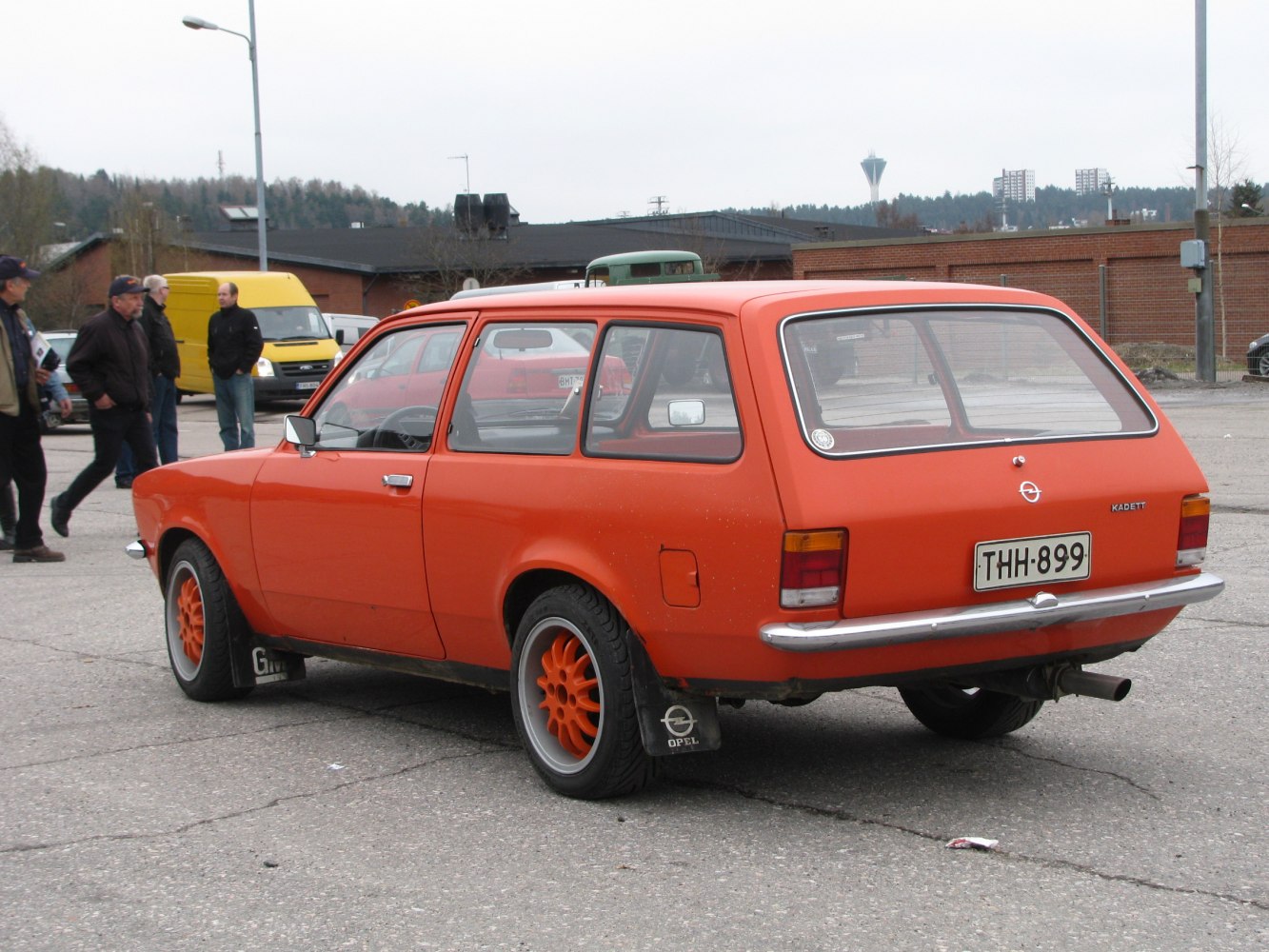 Vintage orange station wagon with sporty wheels and spacious rear design