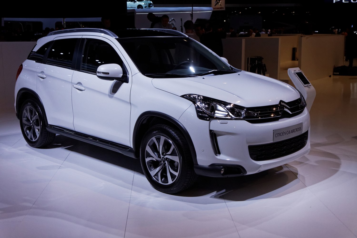 White compact SUV with front-left view, sleek headlights and alloy wheels