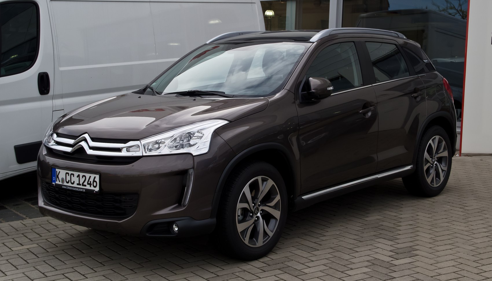 Front three-quarter view of compact SUV showing headlights and grille.