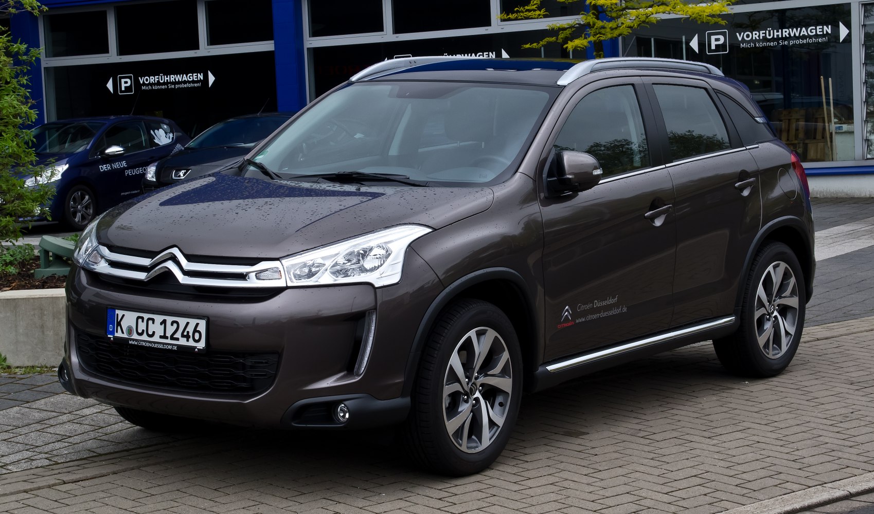 Compact crossover SUV front and side view with headlights and alloy wheels