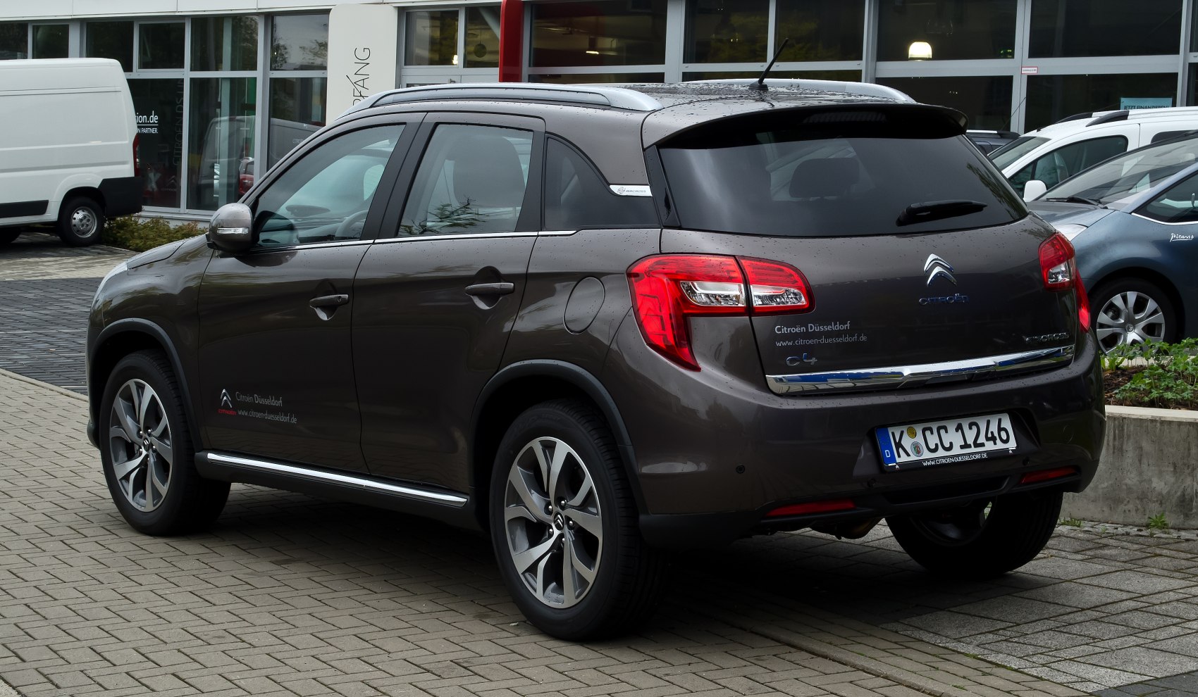 Rear side with sleek taillights, alloy wheels, and roof rails