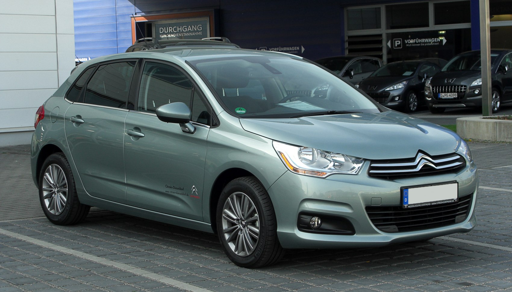 Front-side view of hatchback with headlights and alloy wheels
