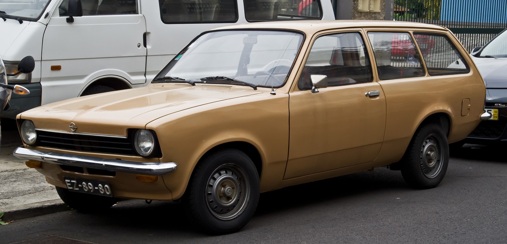 Beige vintage station wagon with round headlights and horizontal grille