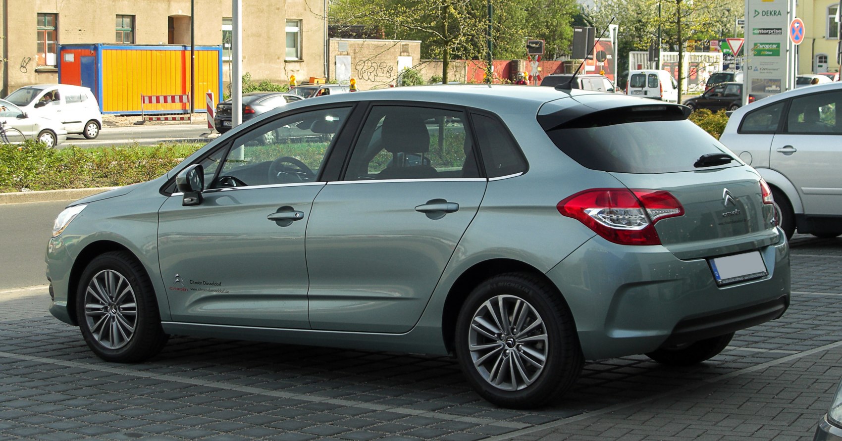 Rear side view of a hatchback with alloy wheels and smooth body lines