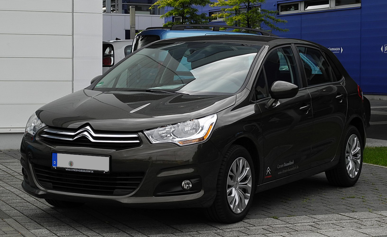 Front side view of hatchback highlighting headlights and grille