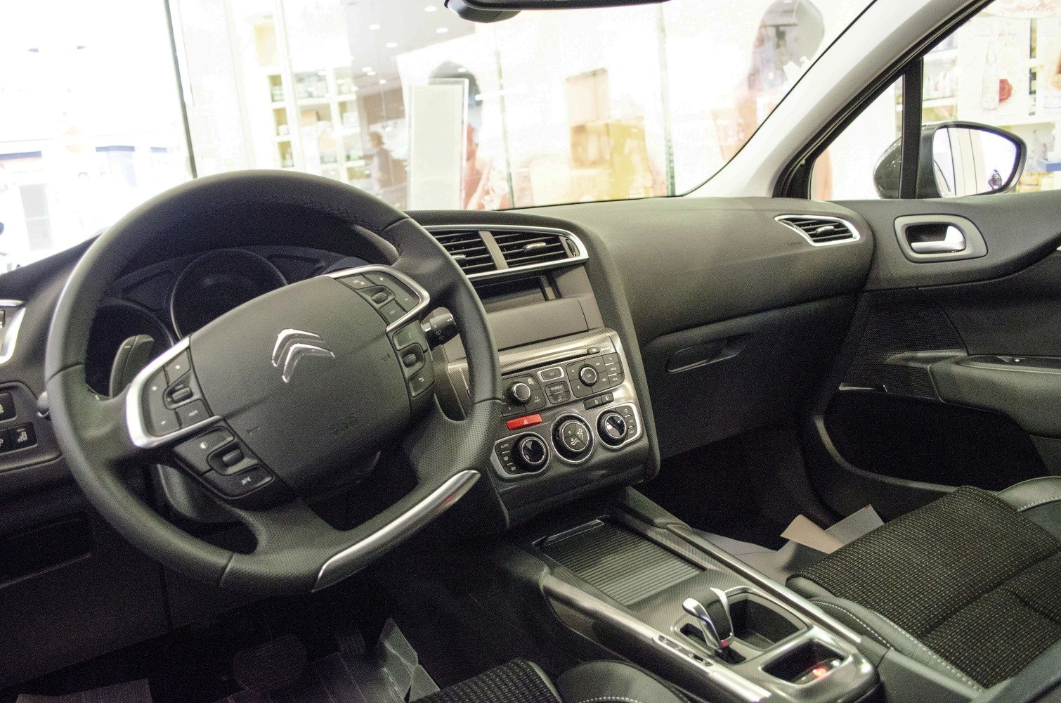 Steering wheel and dashboard with center console controls