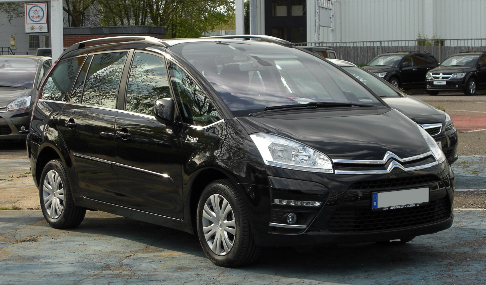 Front and side view of black multi-purpose vehicle with sleek headlights.