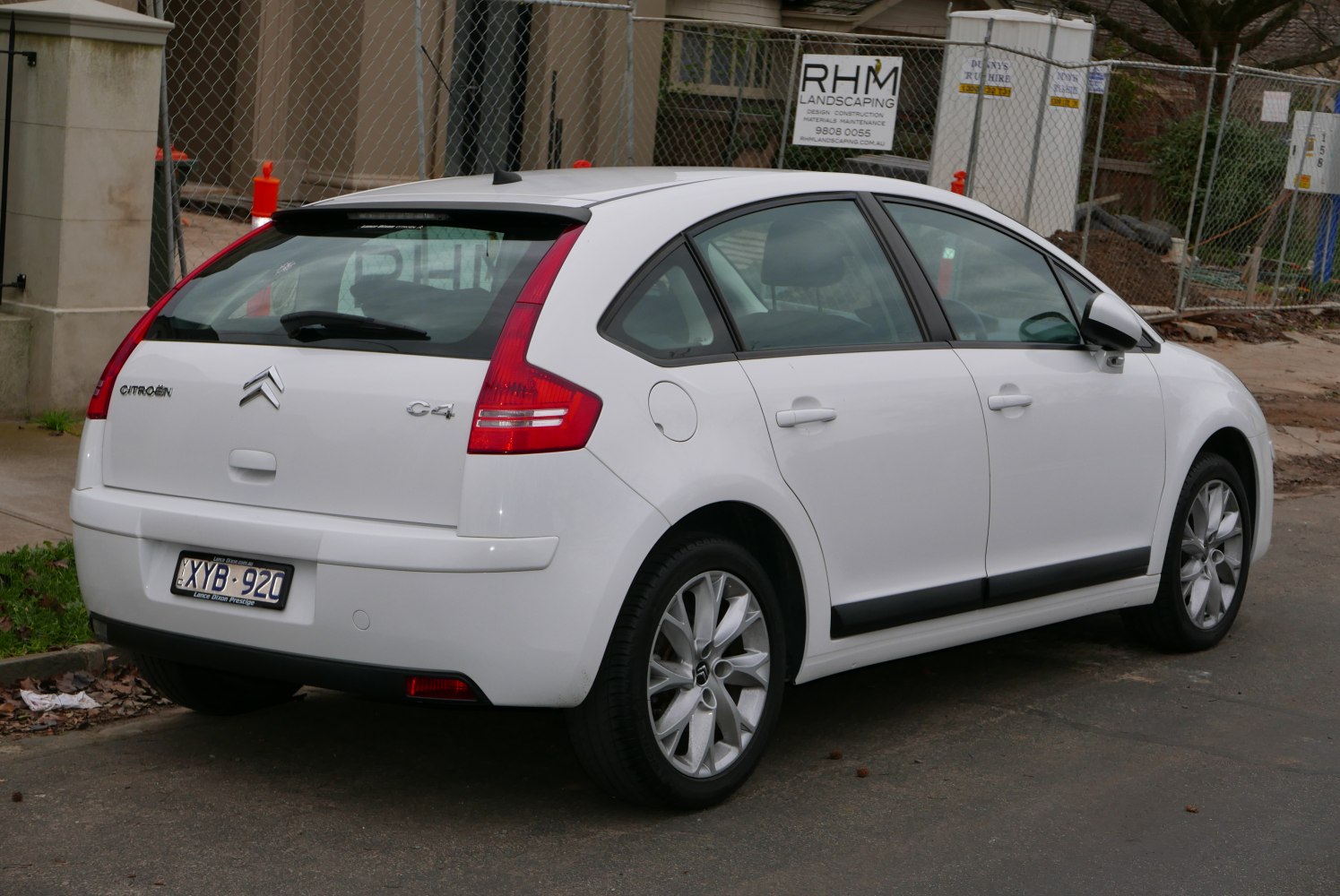 Rear and side view of compact hatchback with vertical tail lights and alloy wheels
