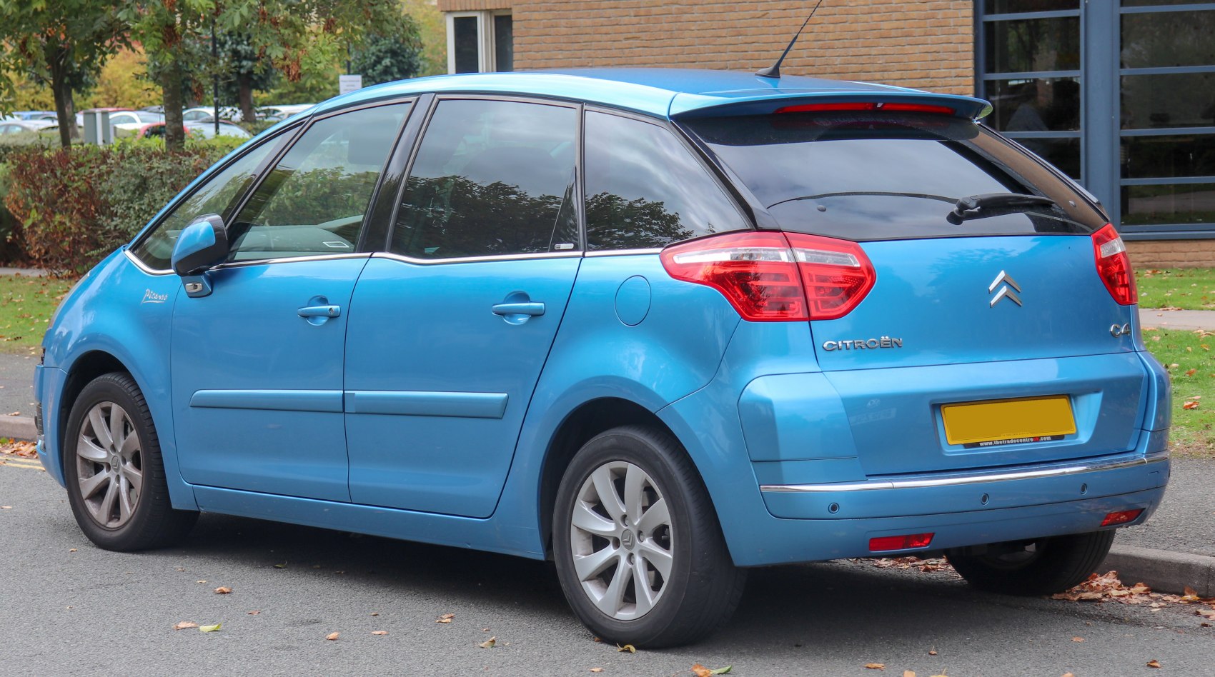 Rear and side view of a compact MPV highlighting tail lights and rear window.