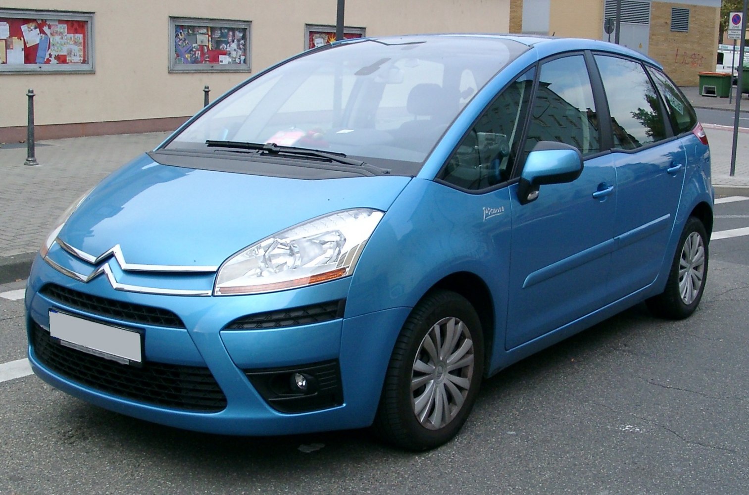Blue compact MPV with large windshield and prominent headlights