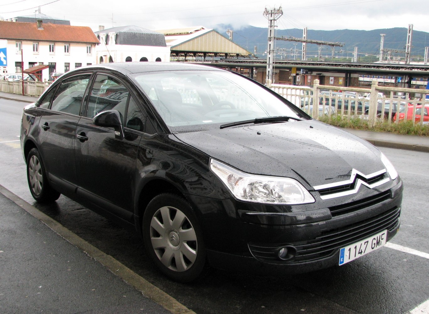 Front-side view of black sedan with distinct headlamps and smooth curves