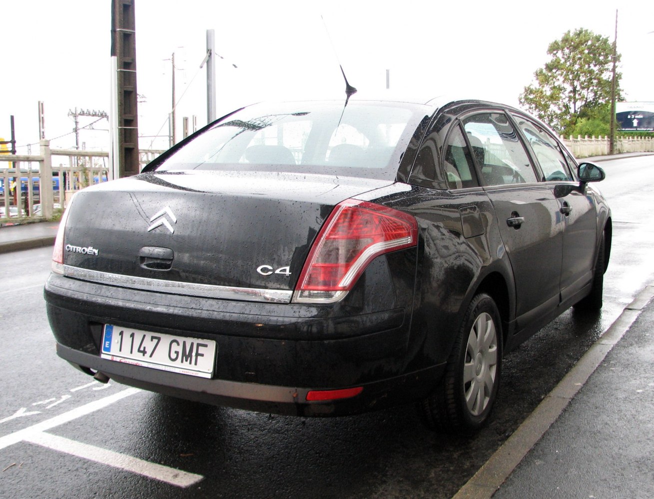 Rear view of a black sedan with distinctive taillights and trim.