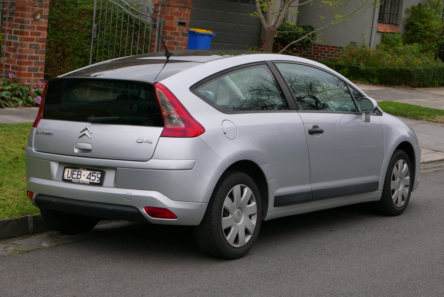 Rear side view of silver hatchback with distinctive taillights